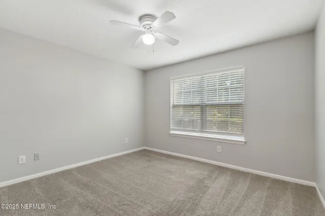 a view of a backyard with table and chairs under an umbrella
