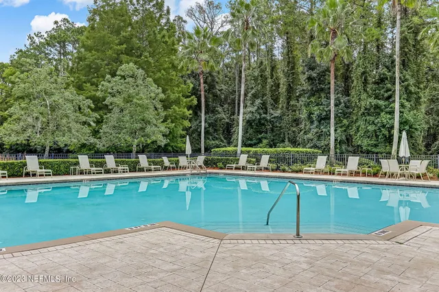 a view of a house with swimming pool and a yard