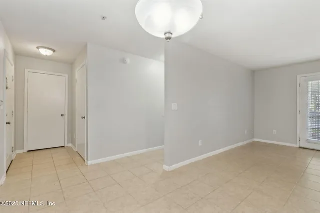 a view of a kitchen with a sink stove cabinets and empty room