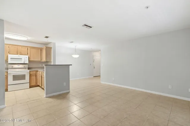 a kitchen with cabinets and stainless steel appliances