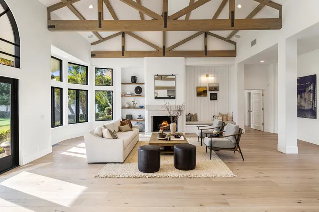 a living room with furniture a fireplace and a table