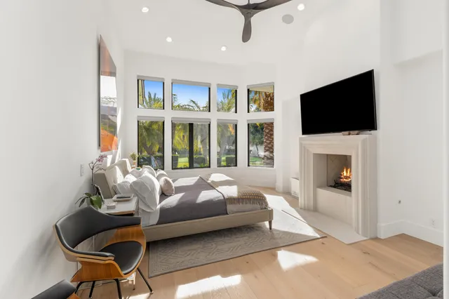 a bedroom with a bed and a large window