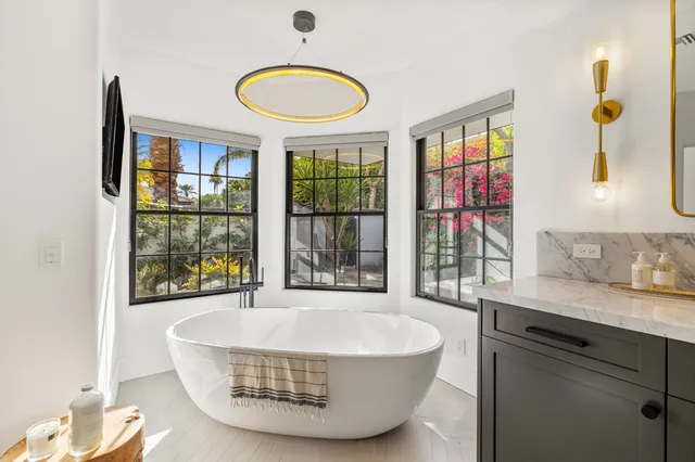 a living room with furniture a fireplace and a ceiling fan