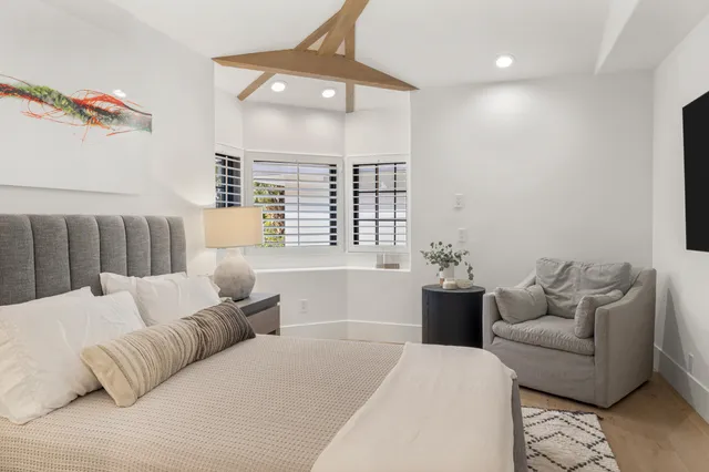 a living room with furniture and large window with outer view