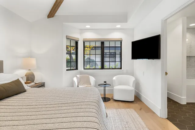 a bedroom with a large bed and a large window