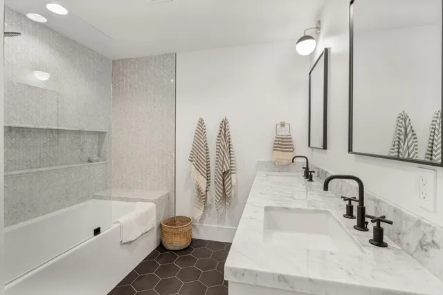 a bedroom with a bed and large mirror