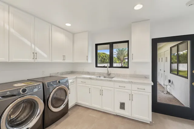 a view of a house with backyard and sitting area