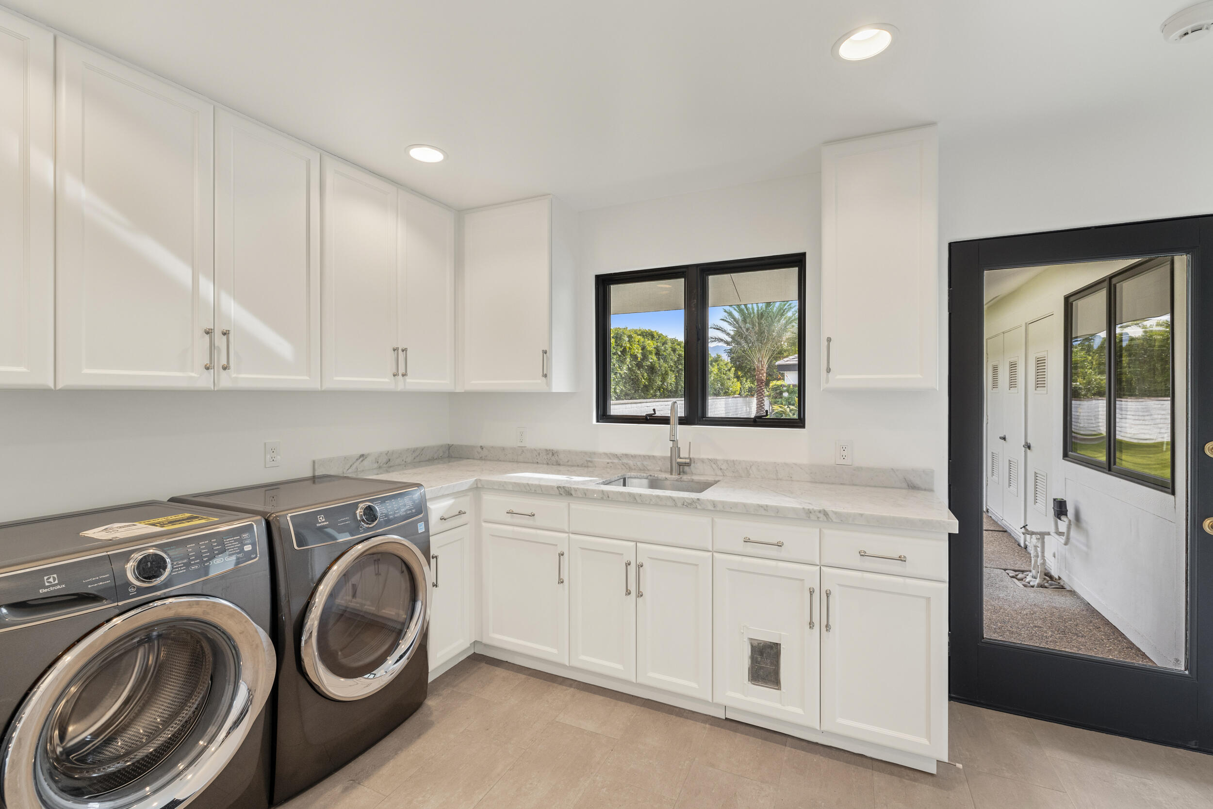 72420 Silver Spur Lane Rancho Mirage, CA 92270 - Photo 41 of 86 a utility room with sink dryer and washer