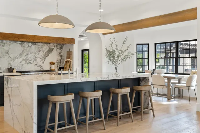 a view of a dining room with furniture large windows and wooden floor