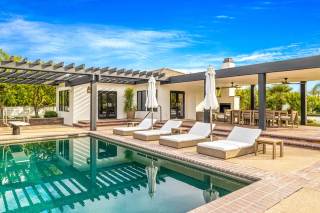 a living room with furniture a fireplace and window