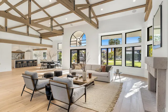 a dining room with furniture and large windows