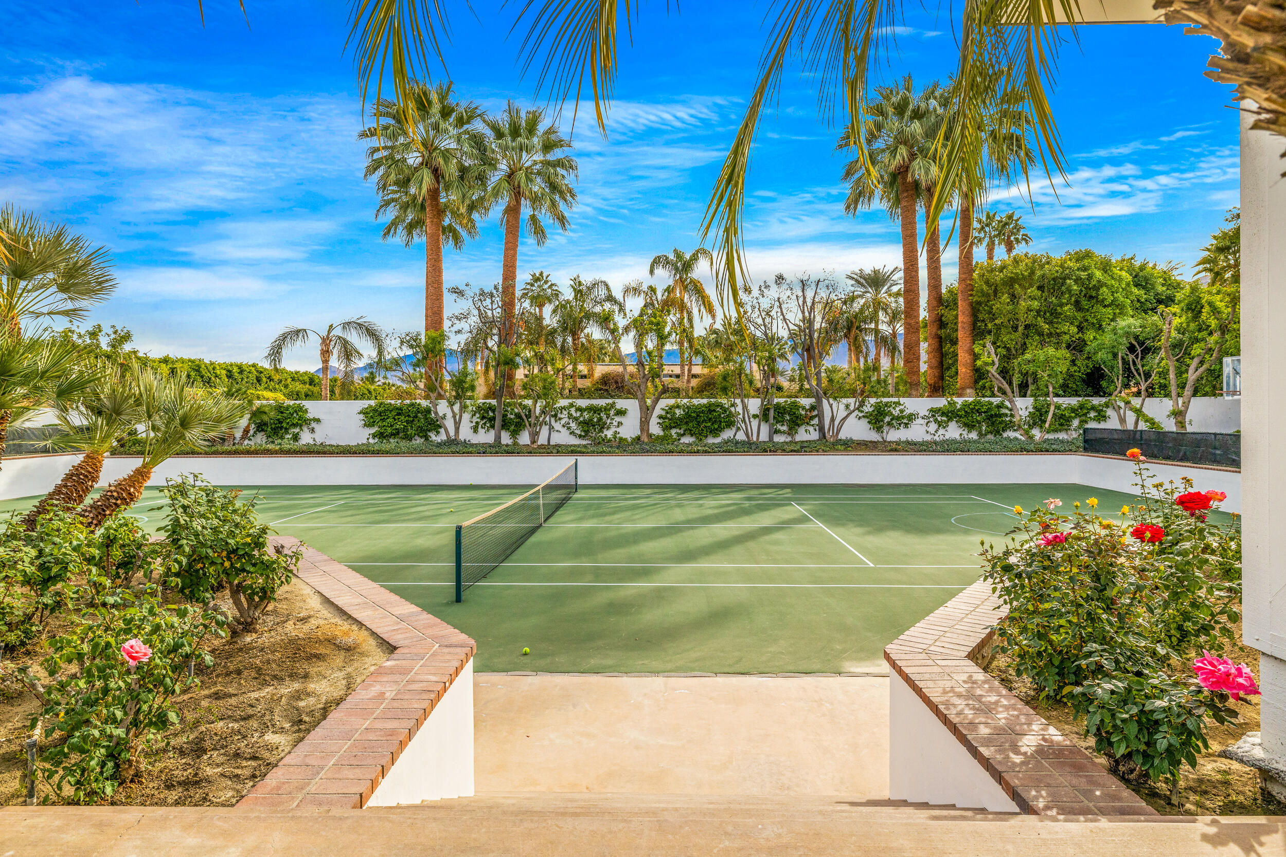 72420 Silver Spur Lane Rancho Mirage, CA 92270 - Photo 78 of 86 a view of a swimming pool with a table and chairs