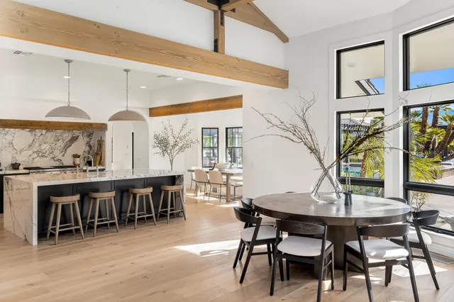 a kitchen with stainless steel appliances granite countertop a stove a sink and a wooden floors