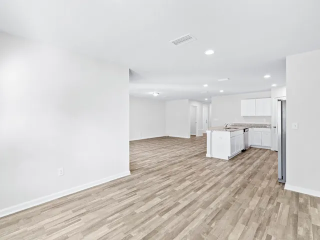 a kitchen with a stove a sink and a refrigerator