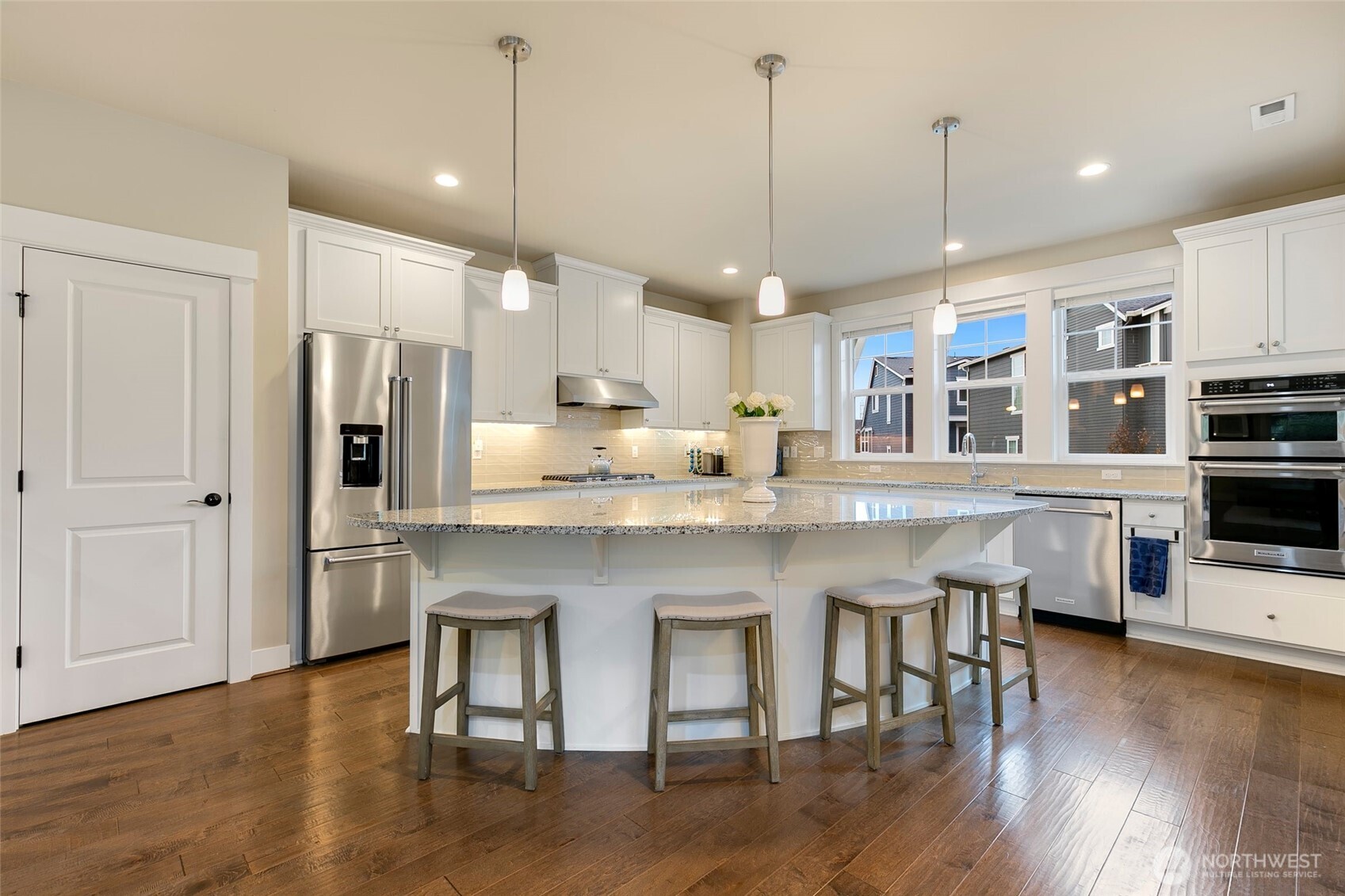 4612 186th Place Southeast, Unit A Bothell, WA 98012 - Photo 2 of 39 a kitchen with stainless steel appliances granite countertop a table chairs stove and microwave
