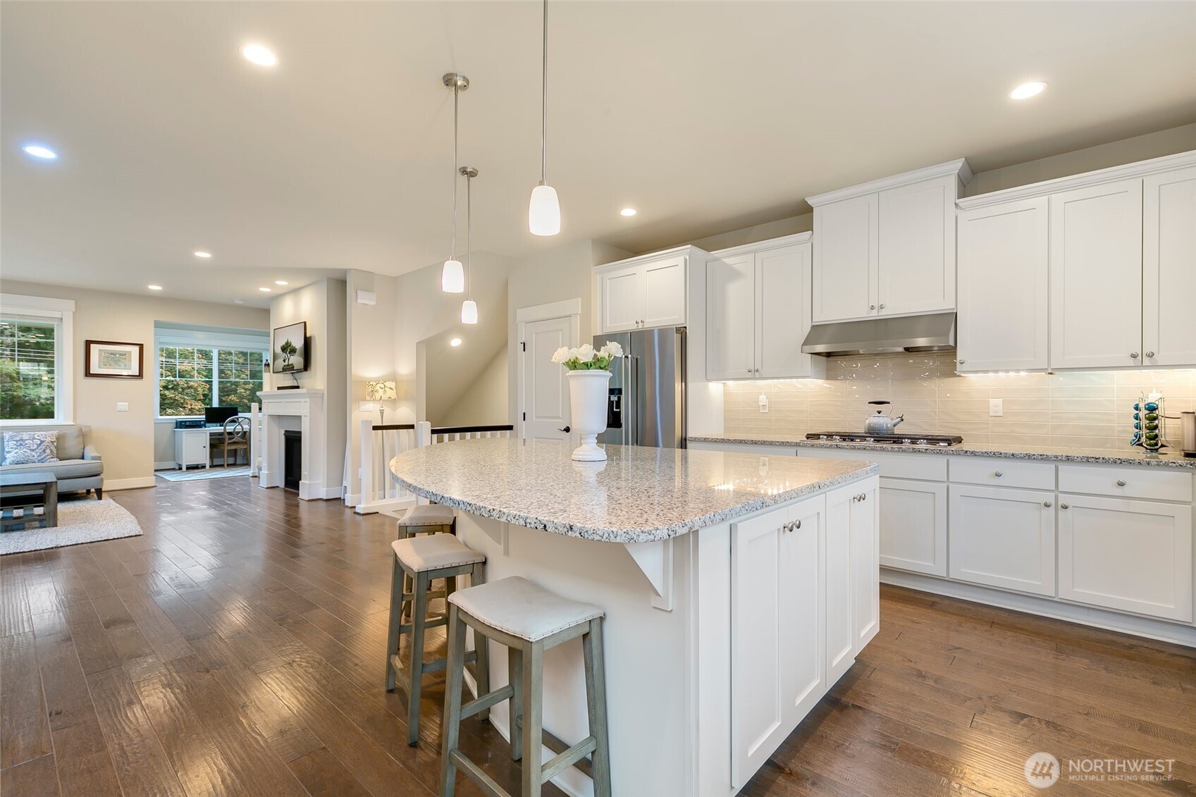 4612 186th Place Southeast, Unit A Bothell, WA 98012 - Photo 4 of 39 a large kitchen with lots of counter space dining table and stainless steel appliances