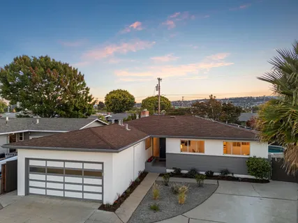 a aerial view of a house with a yard