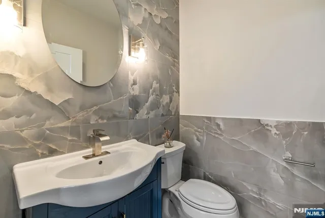 a bathroom with a sink a mirror and a toilet