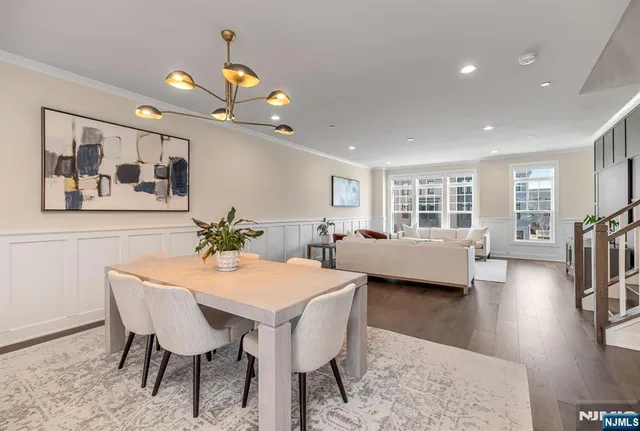 a view of a dining room with furniture and a chandelier