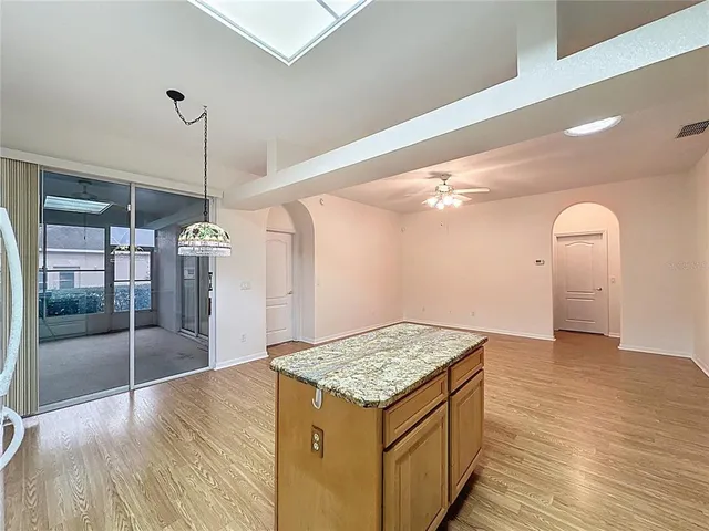 a spacious bedroom with a large bed and a chandelier