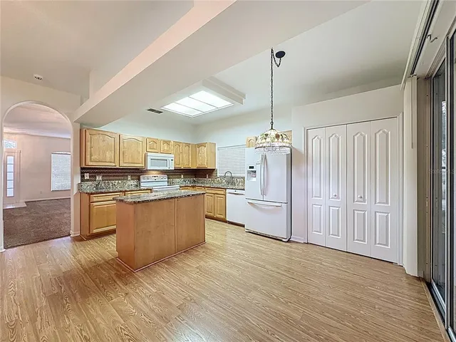 a bathroom with a sink double vanity granite tub shower and a mirror