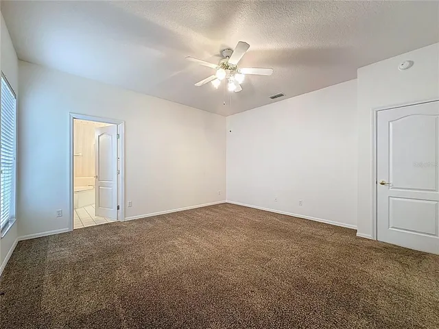 a living room with a bed furniture and a window