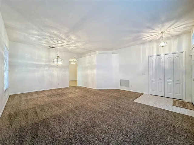 a kitchen with a sink and wooden floor