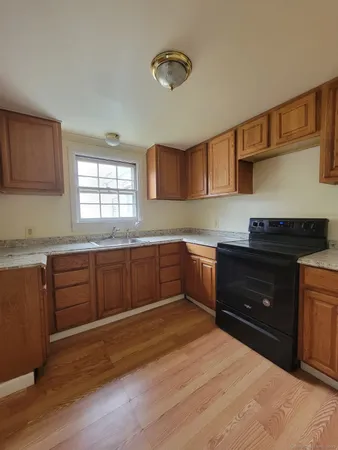 a kitchen with a stove a sink and a microwave