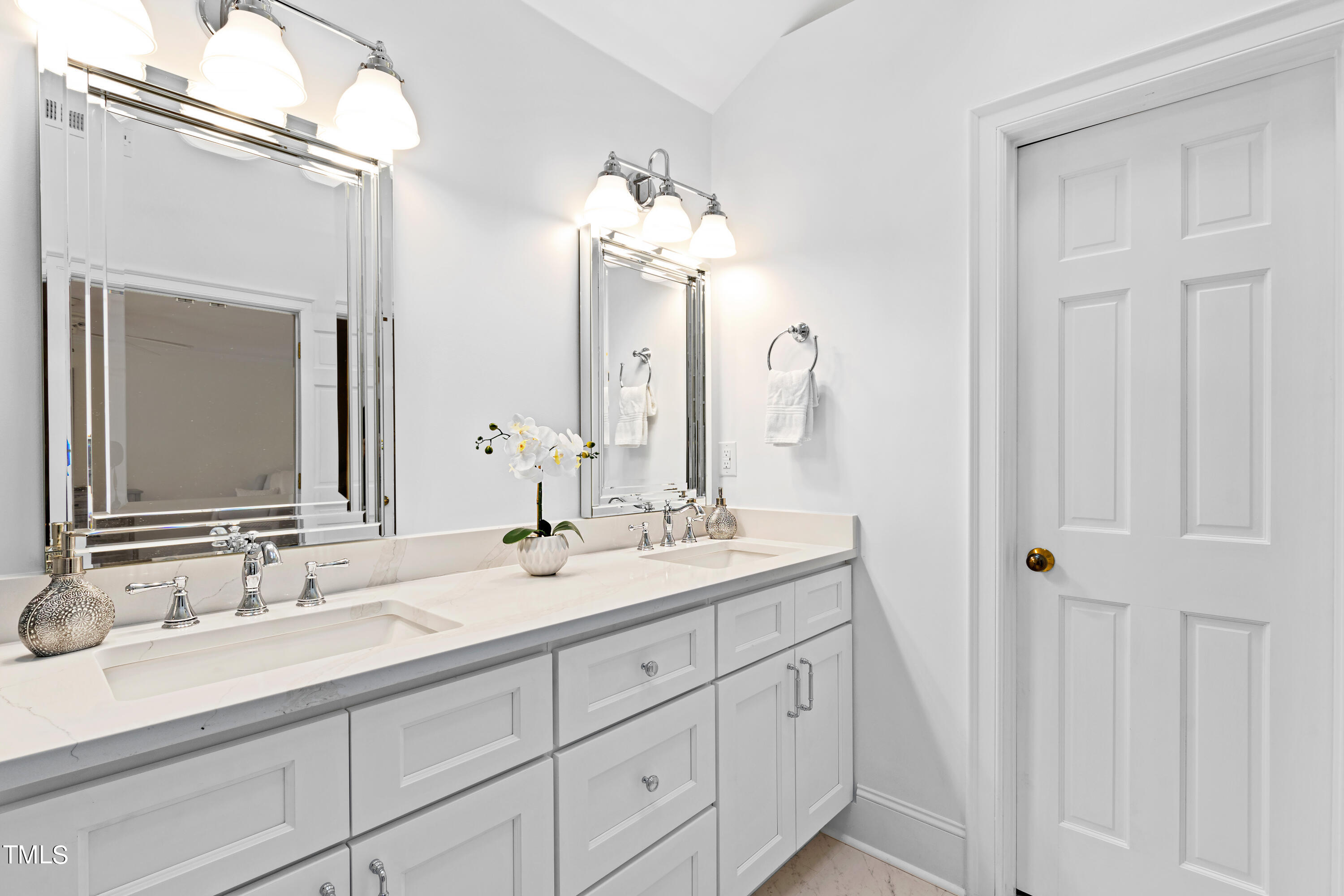 605 Chalfant Court Raleigh, NC 27607 - Photo 23 of 37 a bathroom with double sink and a mirror