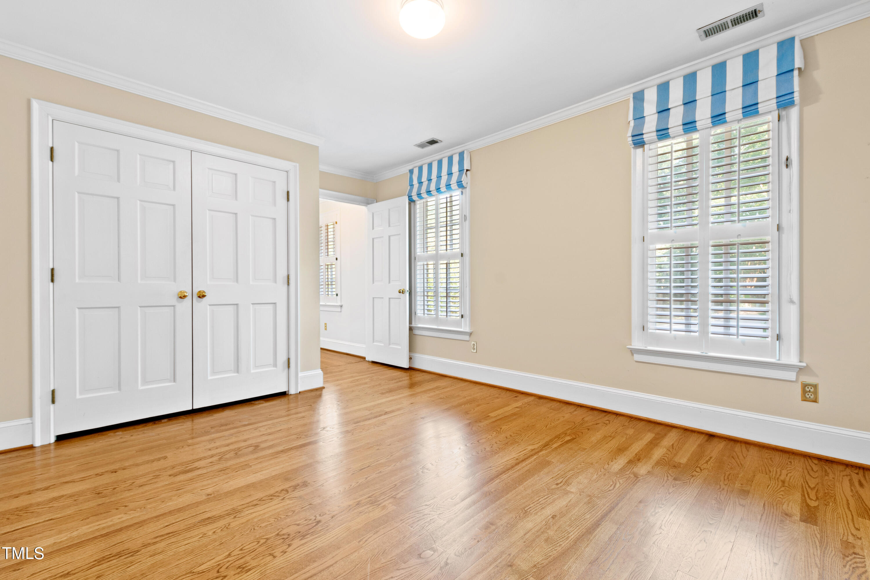 605 Chalfant Court Raleigh, NC 27607 - Photo 27 of 37 a view of an empty room with wooden floor and a window