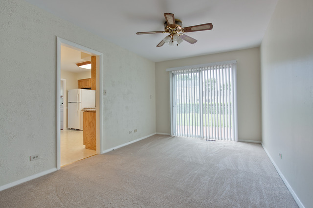 228 Timber Hill Road Buffalo Grove, IL 60089 - Photo 8 of 25 a view of a livingroom with a ceiling fan and window