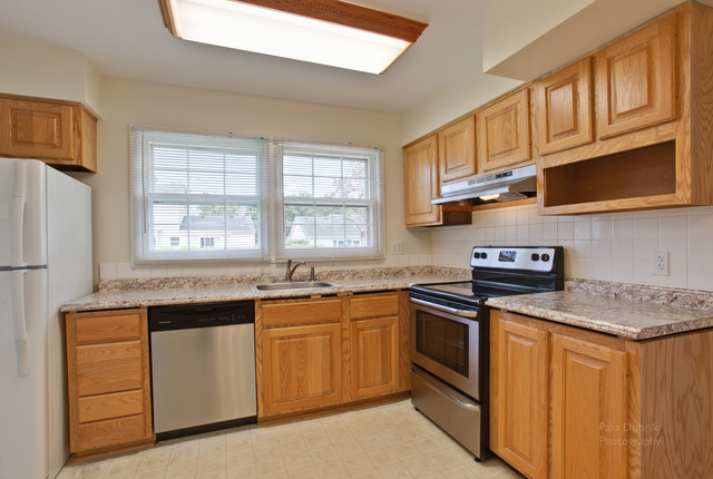 228 Timber Hill Road Buffalo Grove, IL 60089 - Photo 10 of 25 a kitchen with stainless steel appliances granite countertop a stove sink and cabinets