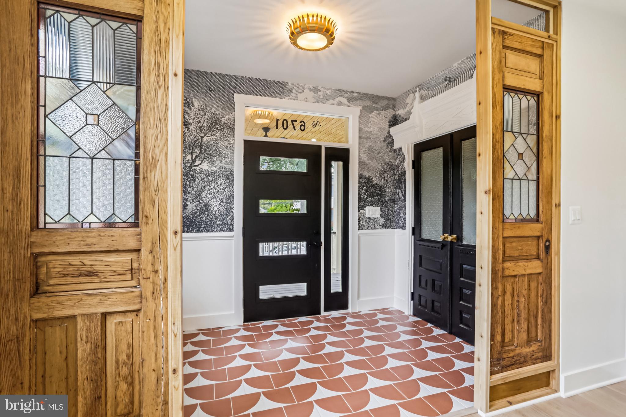 Salvaged architectural doors frame custom tile.