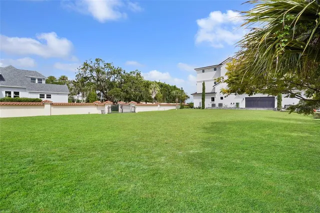 a view of a yard with a house in the background