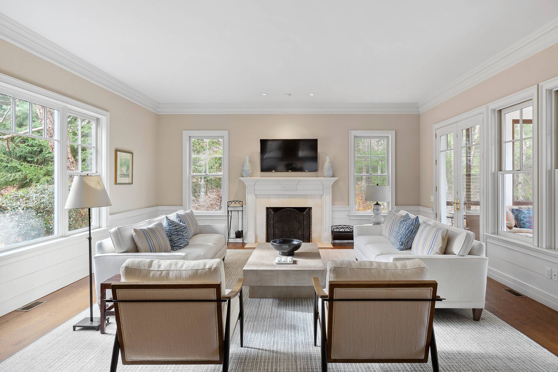 a living room with furniture a fireplace and a flat screen tv