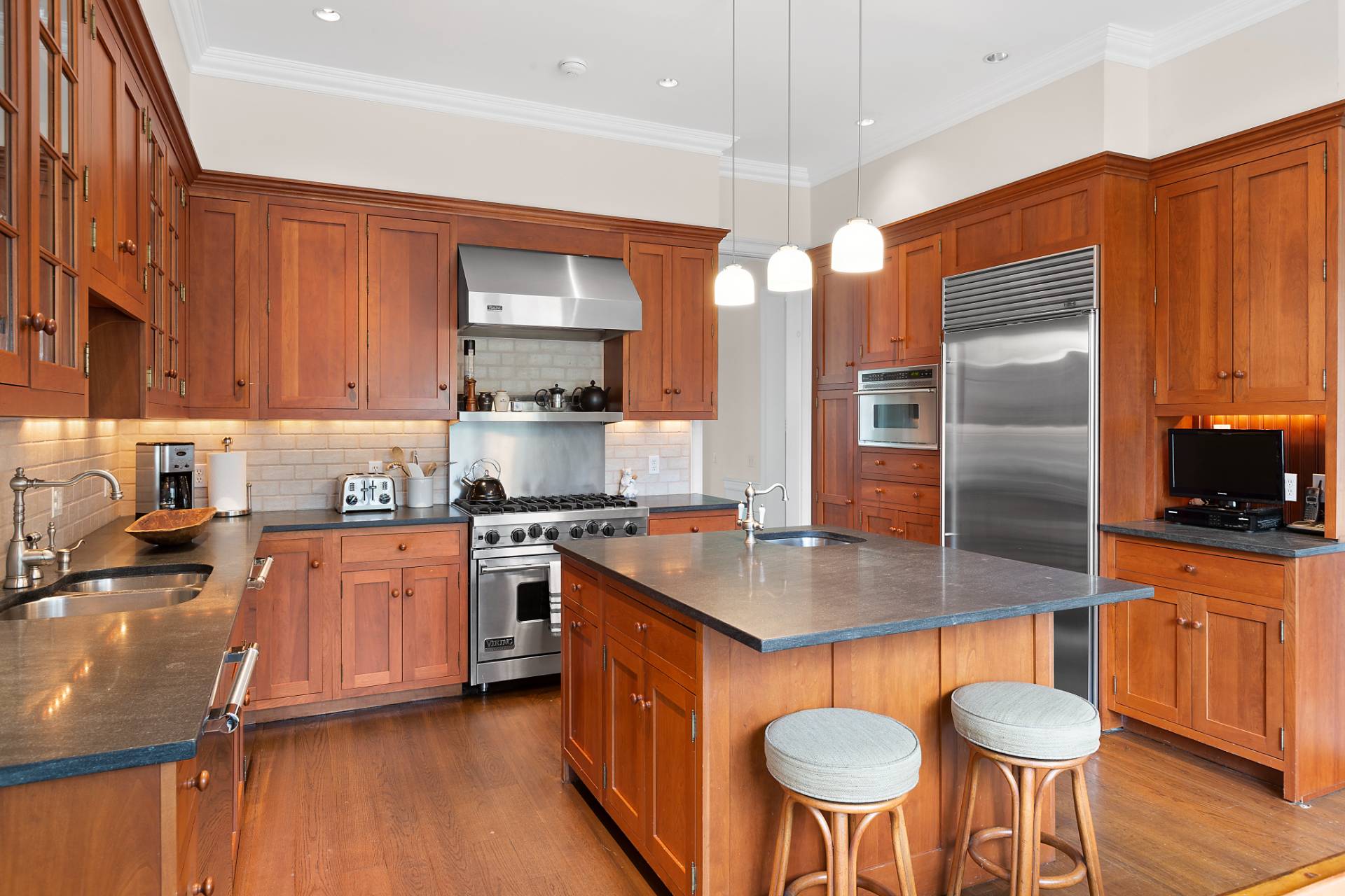 142 Bull Path East Hampton, NY 11937 - Photo 3 of 13 a kitchen with stainless steel appliances granite countertop a sink a stove and a refrigerator