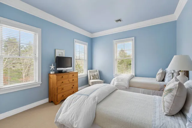 a bedroom with a bed and a television