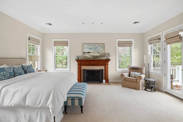 a spacious bedroom with a bed and a fireplace