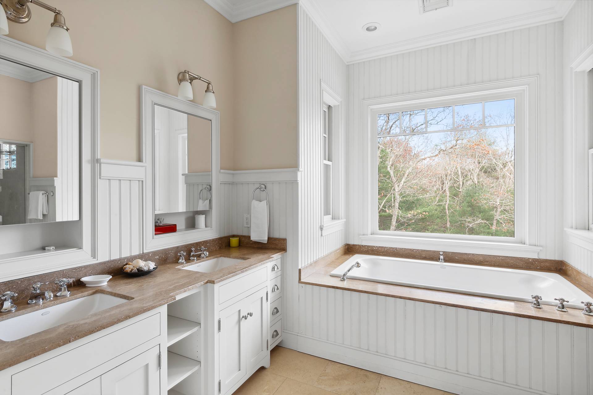 142 Bull Path East Hampton, NY 11937 - Photo 9 of 13 a bathroom with a granite countertop tub sink and mirror next to a window