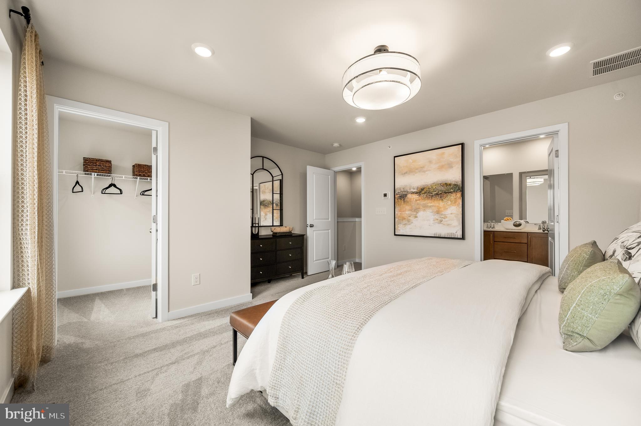206 Bronze Street Phoenixville, PA 19460 - Photo 16 of 31 a bedroom with a large bed and a chandelier