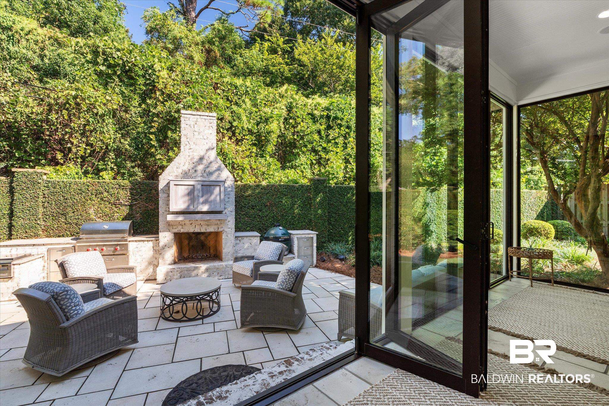 320 Long Court Mobile, AL 36608 - Photo 10 of 61 Exterior space featuring an outdoor stone fireplace, exterior kitchen, and area for grilling