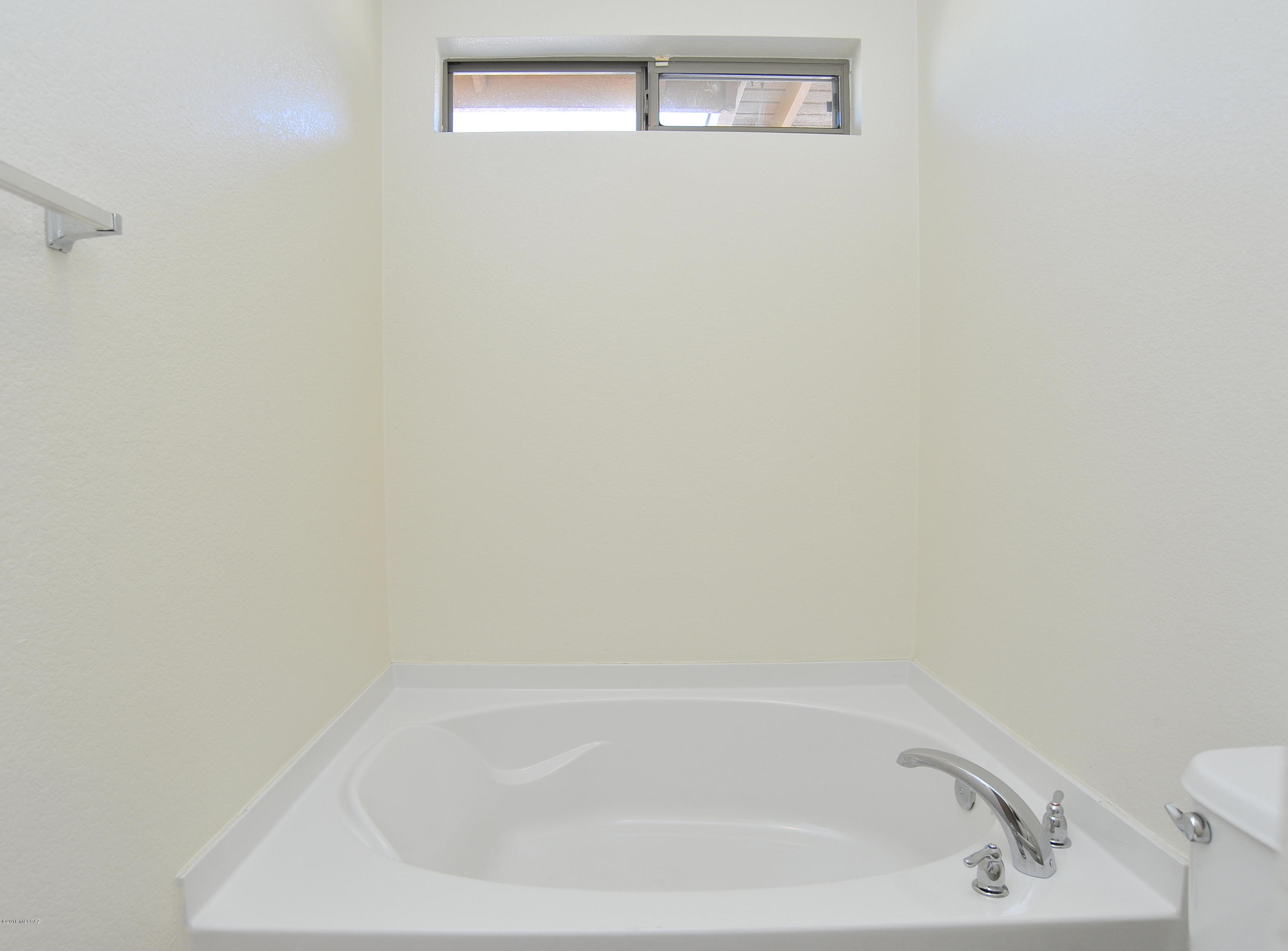 558 West Chatfield Street Vail, AZ 85641 - Photo 18 of 31 a white bath tub sitting next to a white toilet