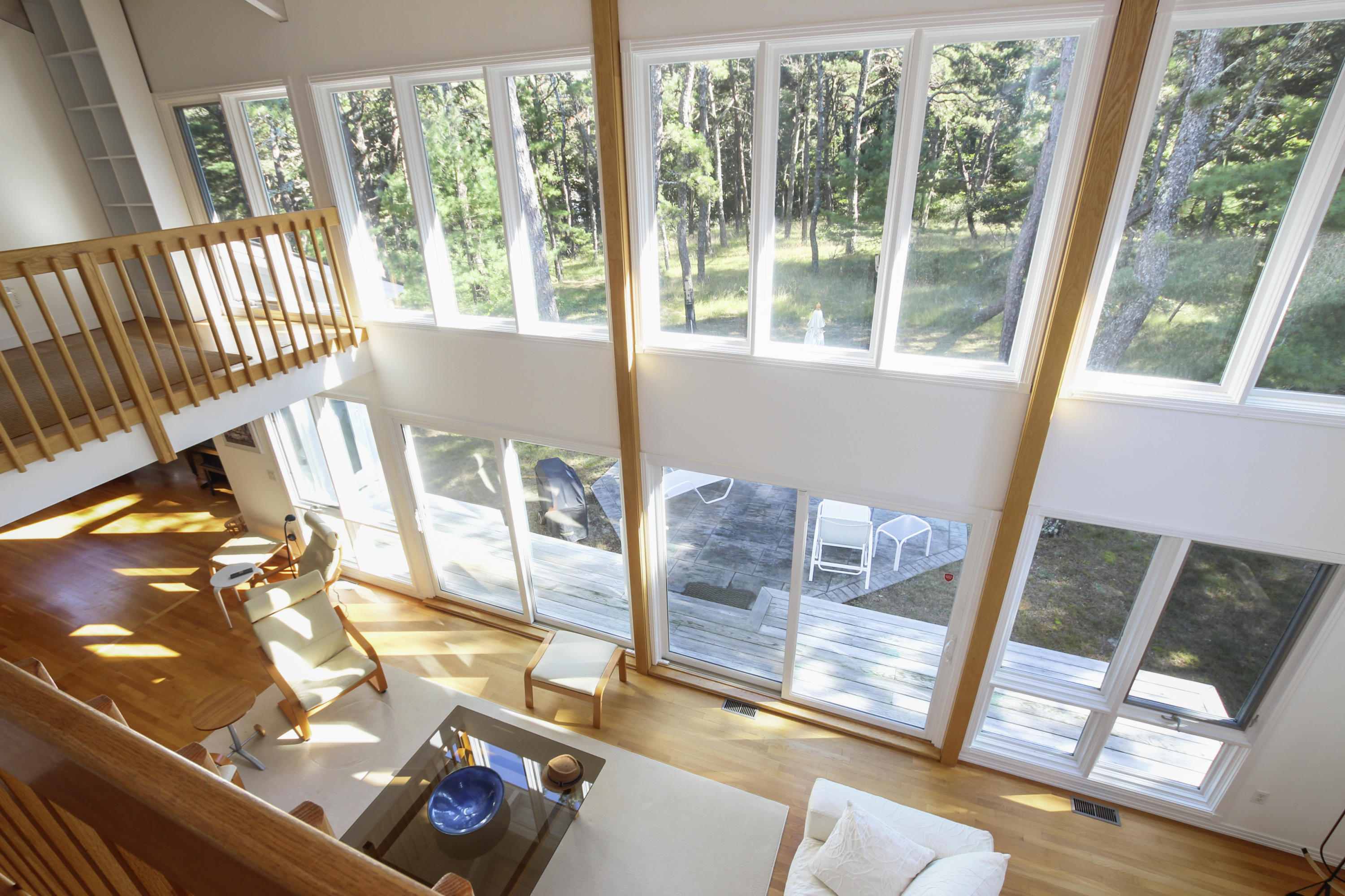 164 Long Pond Road Wellfleet, MA 02667 - Photo 19 of 33 a living room with a floor to ceiling window and wooden floor