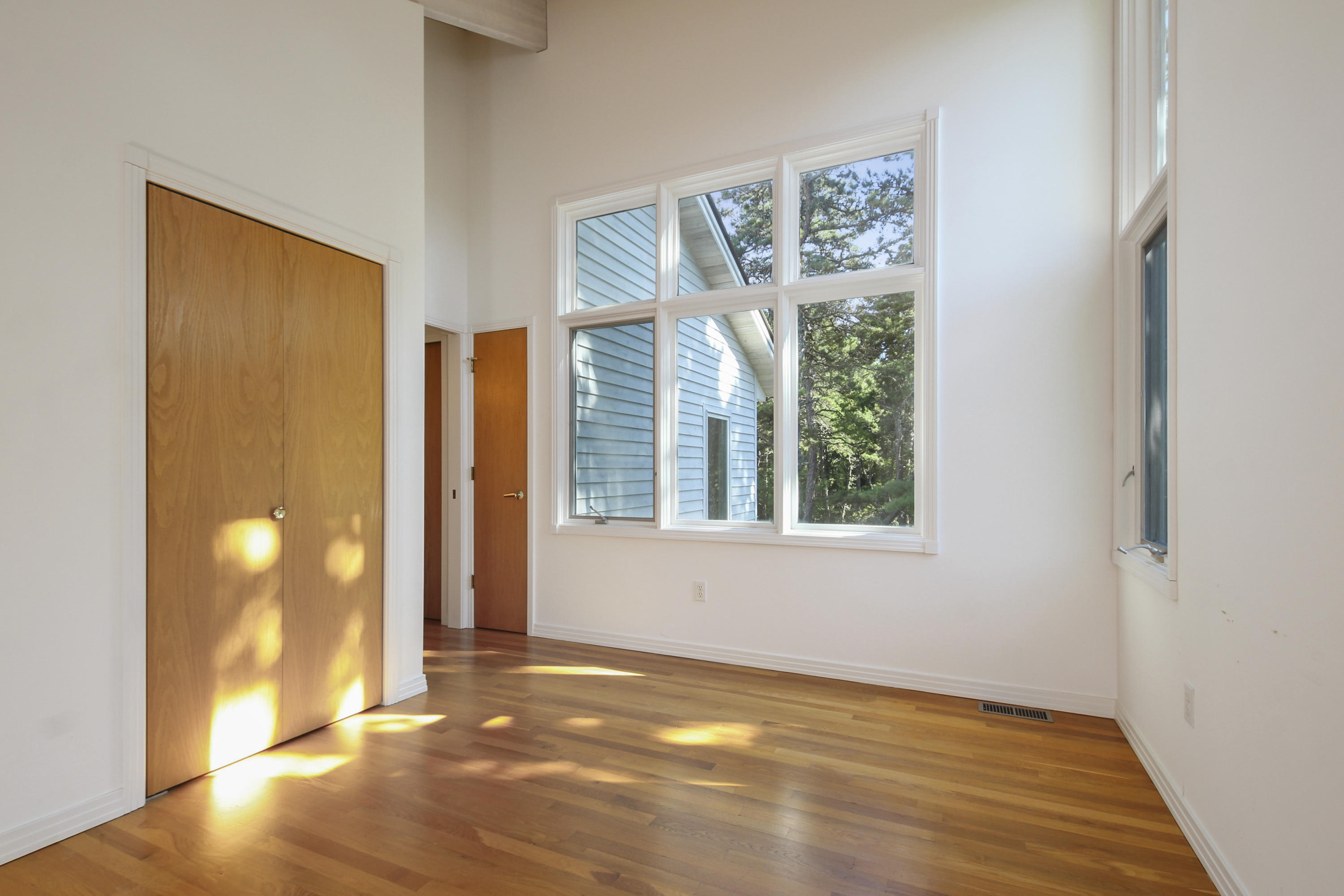 164 Long Pond Road Wellfleet, MA 02667 - Photo 25 of 33 a view of an empty room with wooden floor and a window