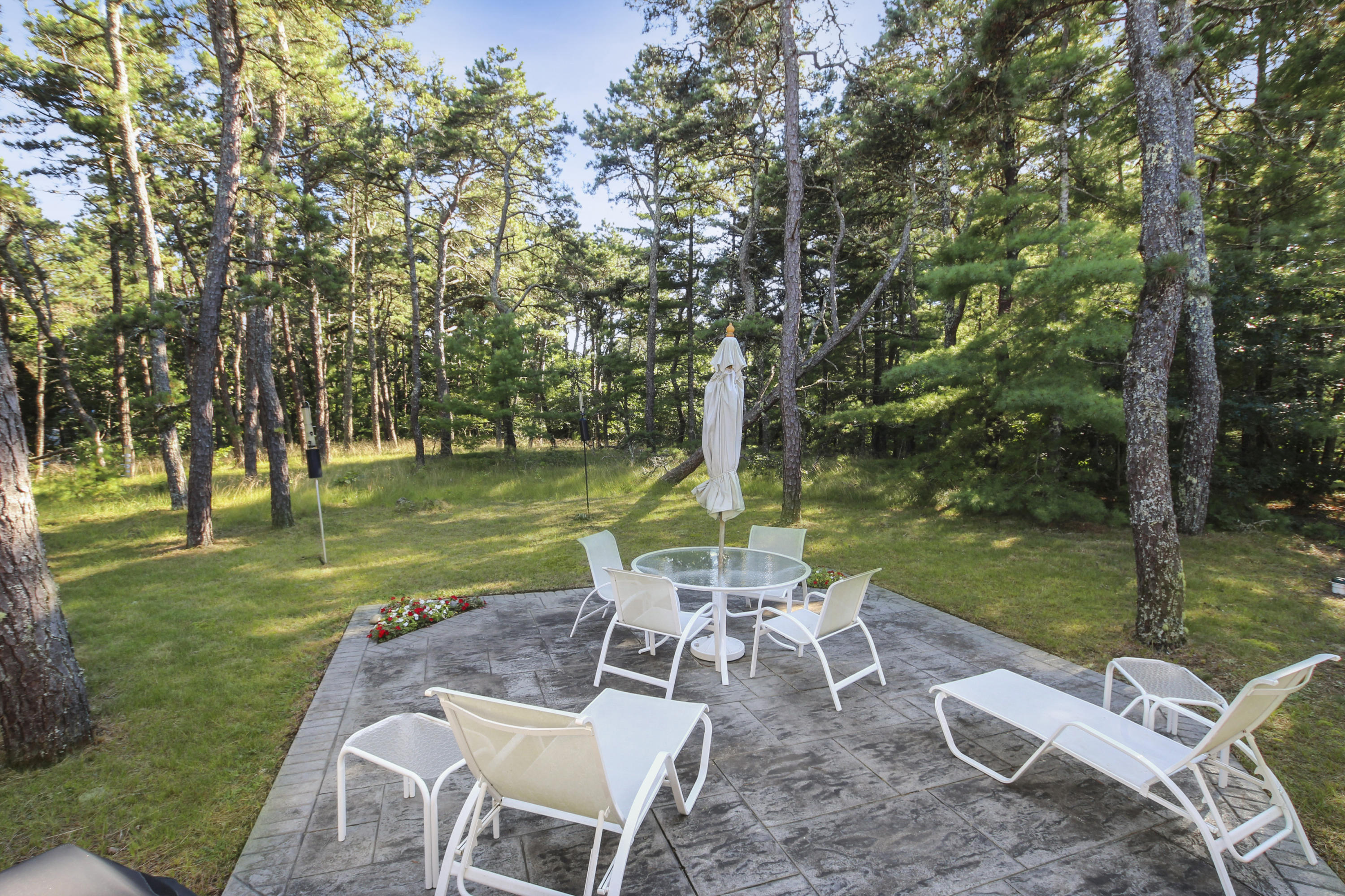 164 Long Pond Road Wellfleet, MA 02667 - Photo 7 of 33 a view of a table and chairs in the garden