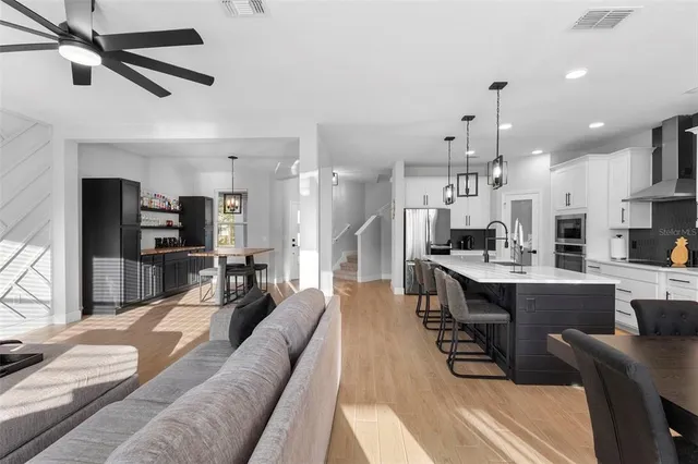 a large kitchen with a table and chairs