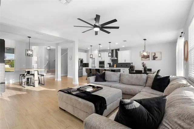 a living room with furniture and a chandelier