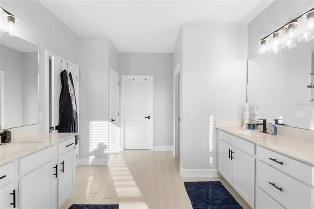 a bathroom with a double vanity sink and mirror