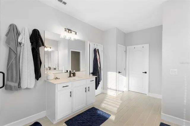 a bathroom with a double vanity sink and a mirror