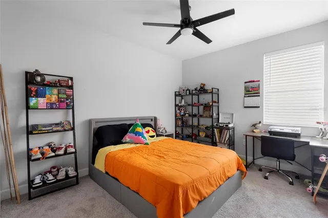 a bedroom with a bed a dresser and a book shelf